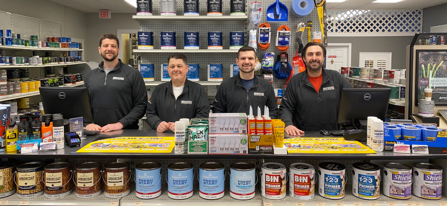 a group of men standing behind a counter in a store