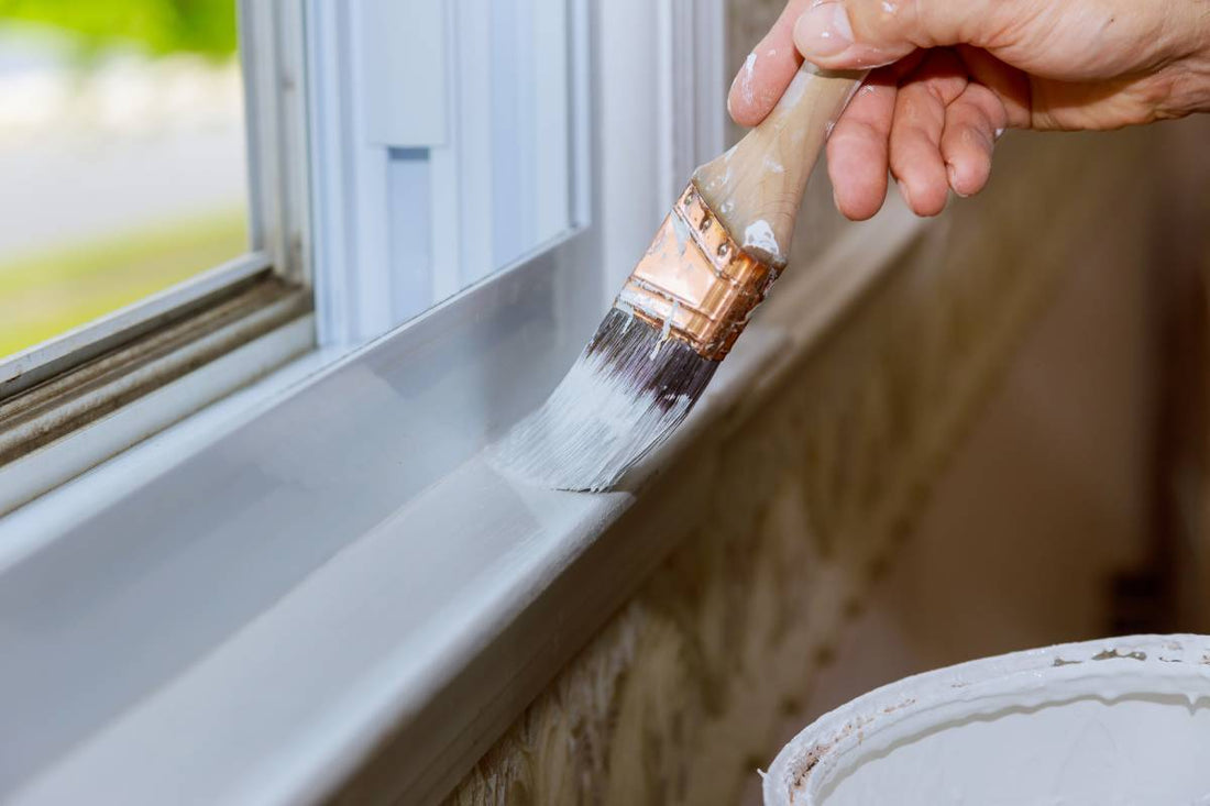 Someone painting the windowsill white near Montclair, NJ